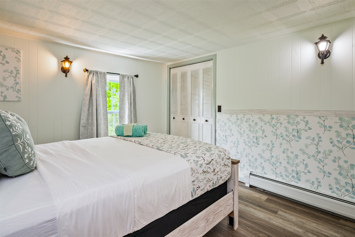Wake up refreshed in this light-filled room with charming decor, ample storage, and calming, nature-inspired touches.