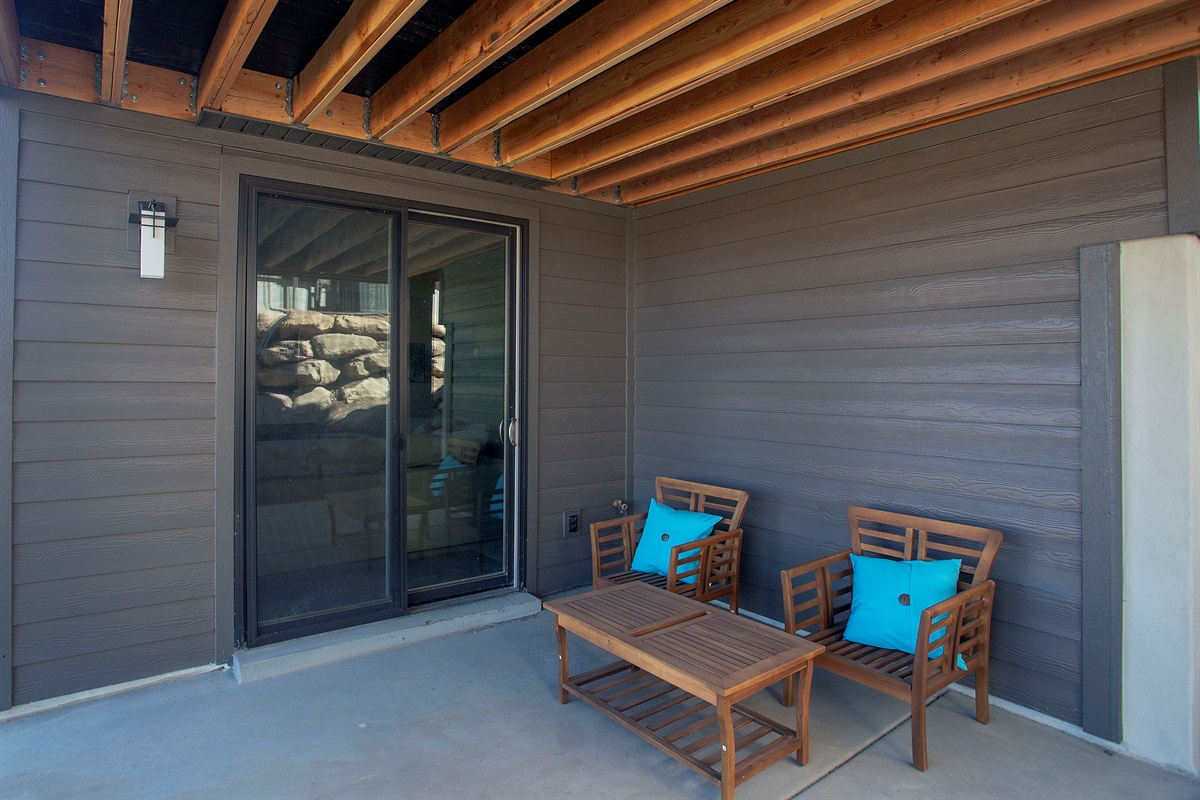 Covered patio with outdoor seating—great for morning coffee or evening relaxation.