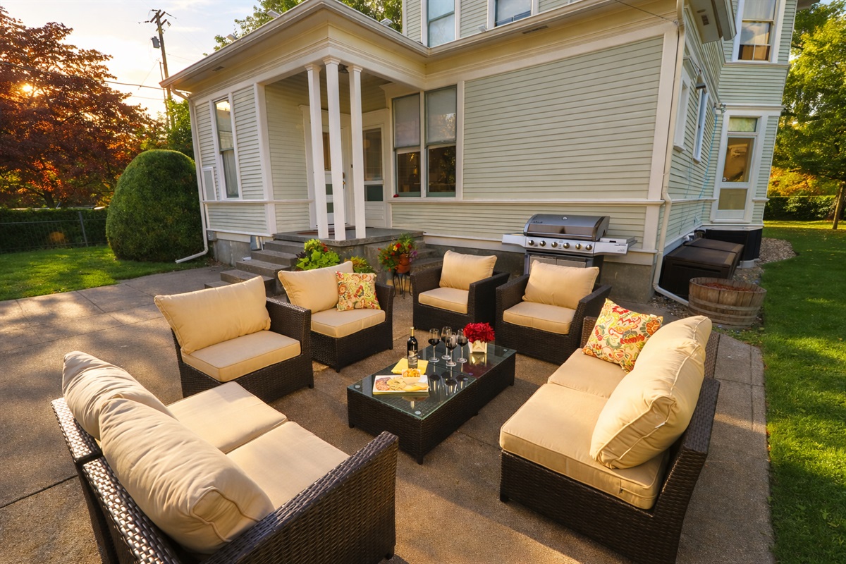 Back patio, surrounded by mature trees and historic charm and equipped with lounge seating and BBQ (propane provided)