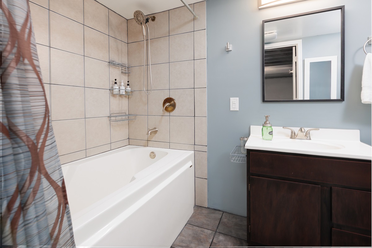 Basement bathroom with a six-foot tub and shower combination for added comfort.