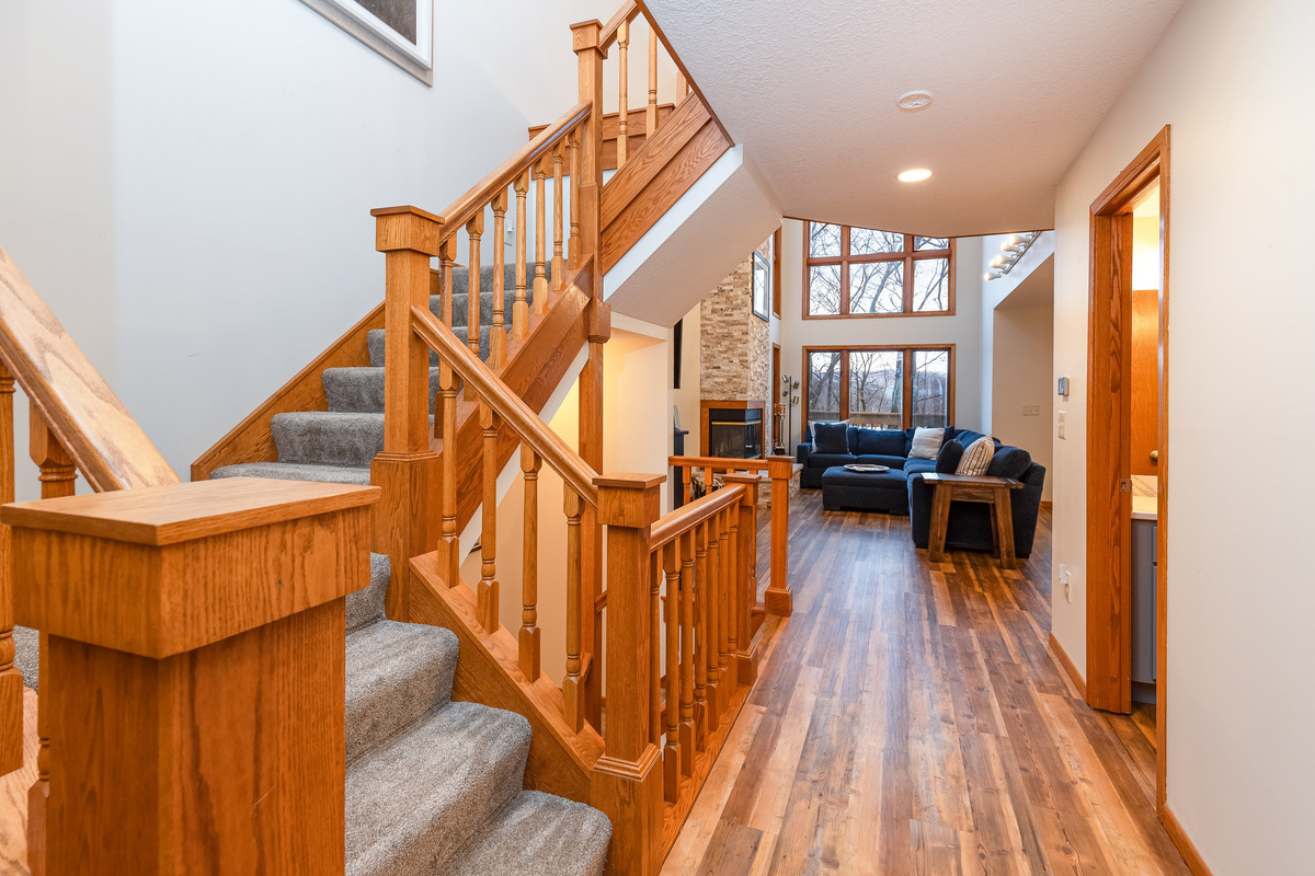 Steps leading upstairs to the Primary bedroom & steps to the lower level