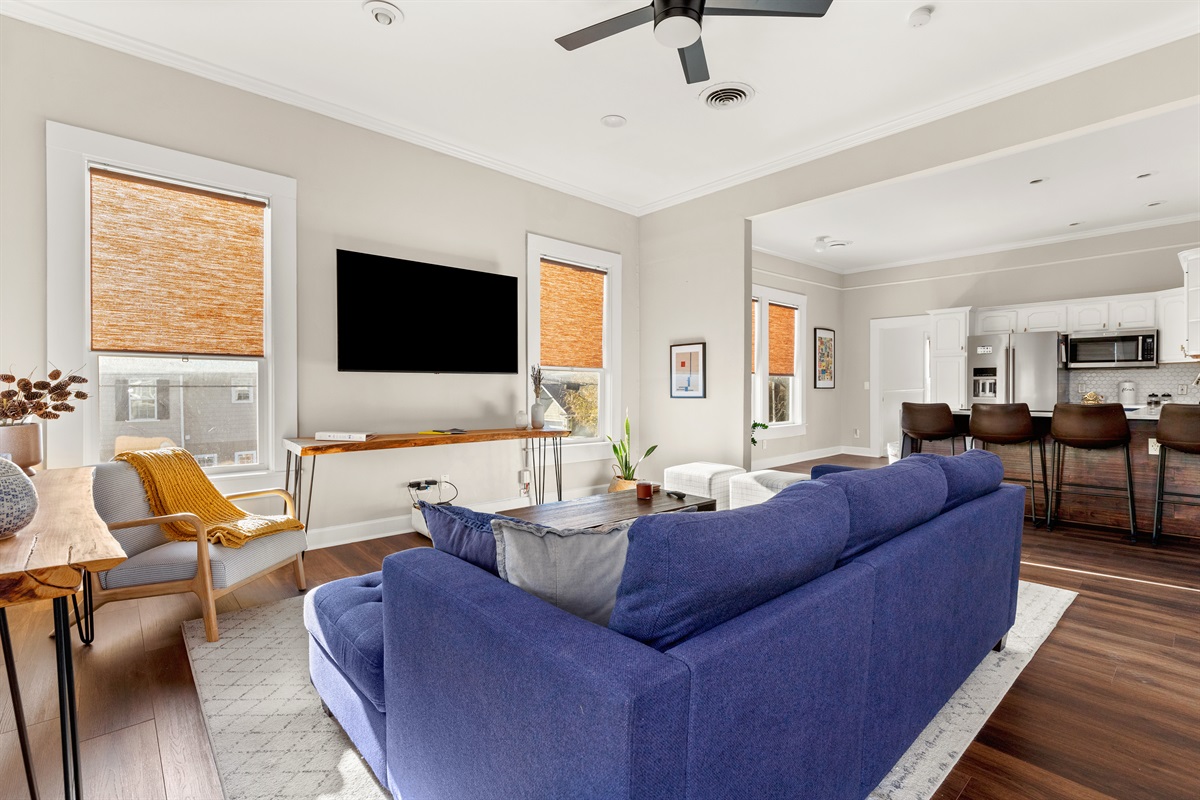 "Comfort meets entertainment in this living room haven – a place where the sofa beckons and the TV sparks joy in every frame