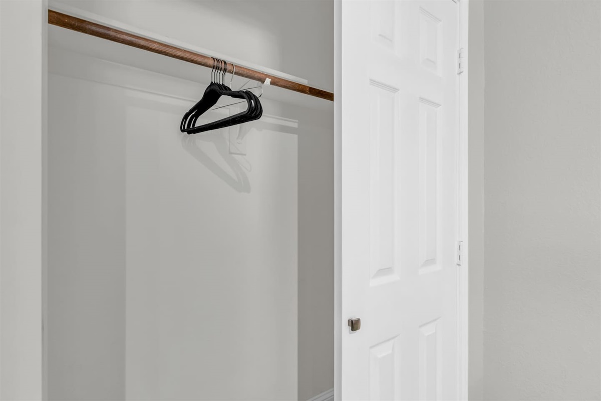Clean, well-organized closet offering generous storage for clothing, luggage, and longer stays.