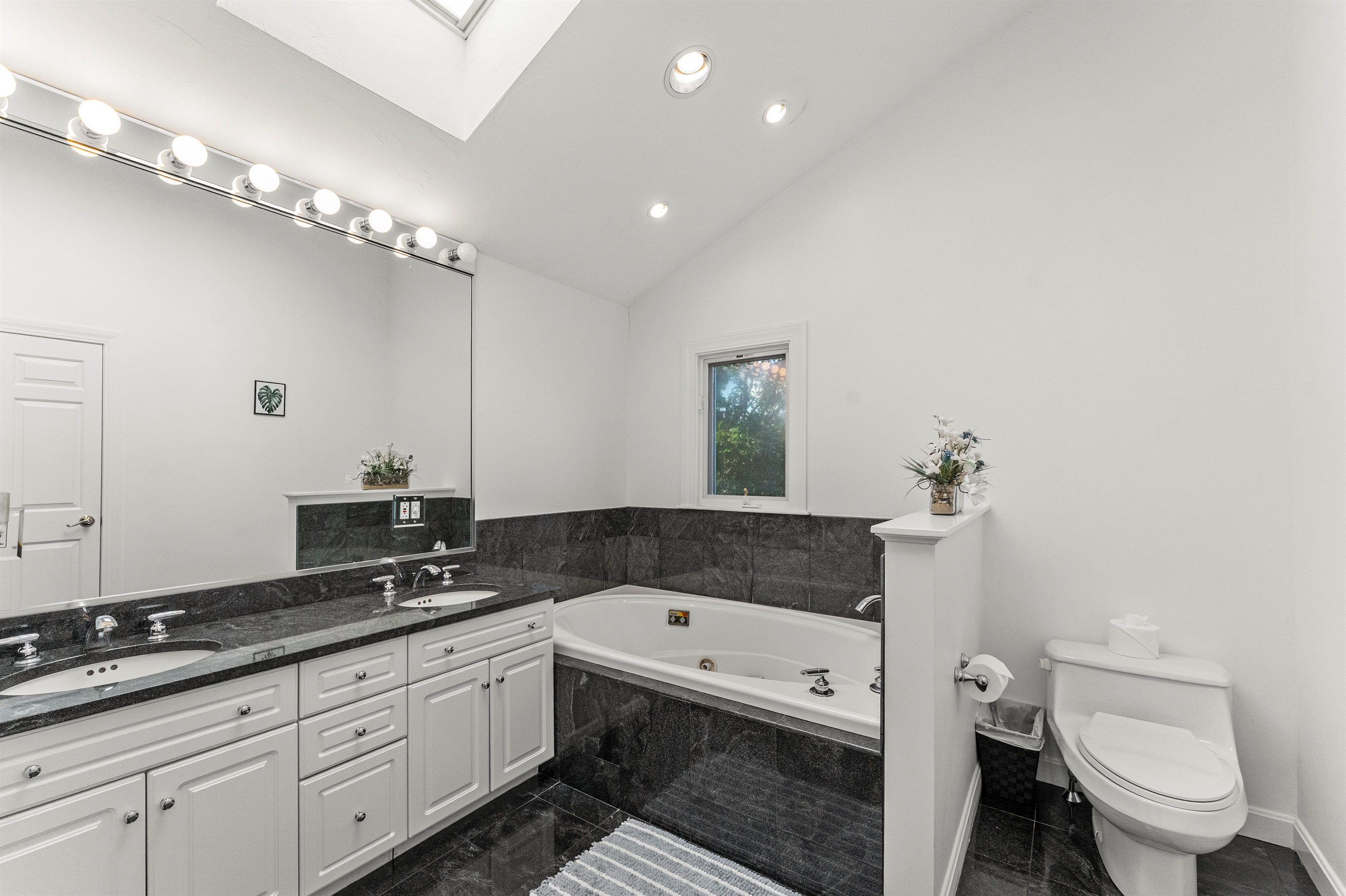 Relax in the queen ensuite featuring a jetted tub and standing shower.