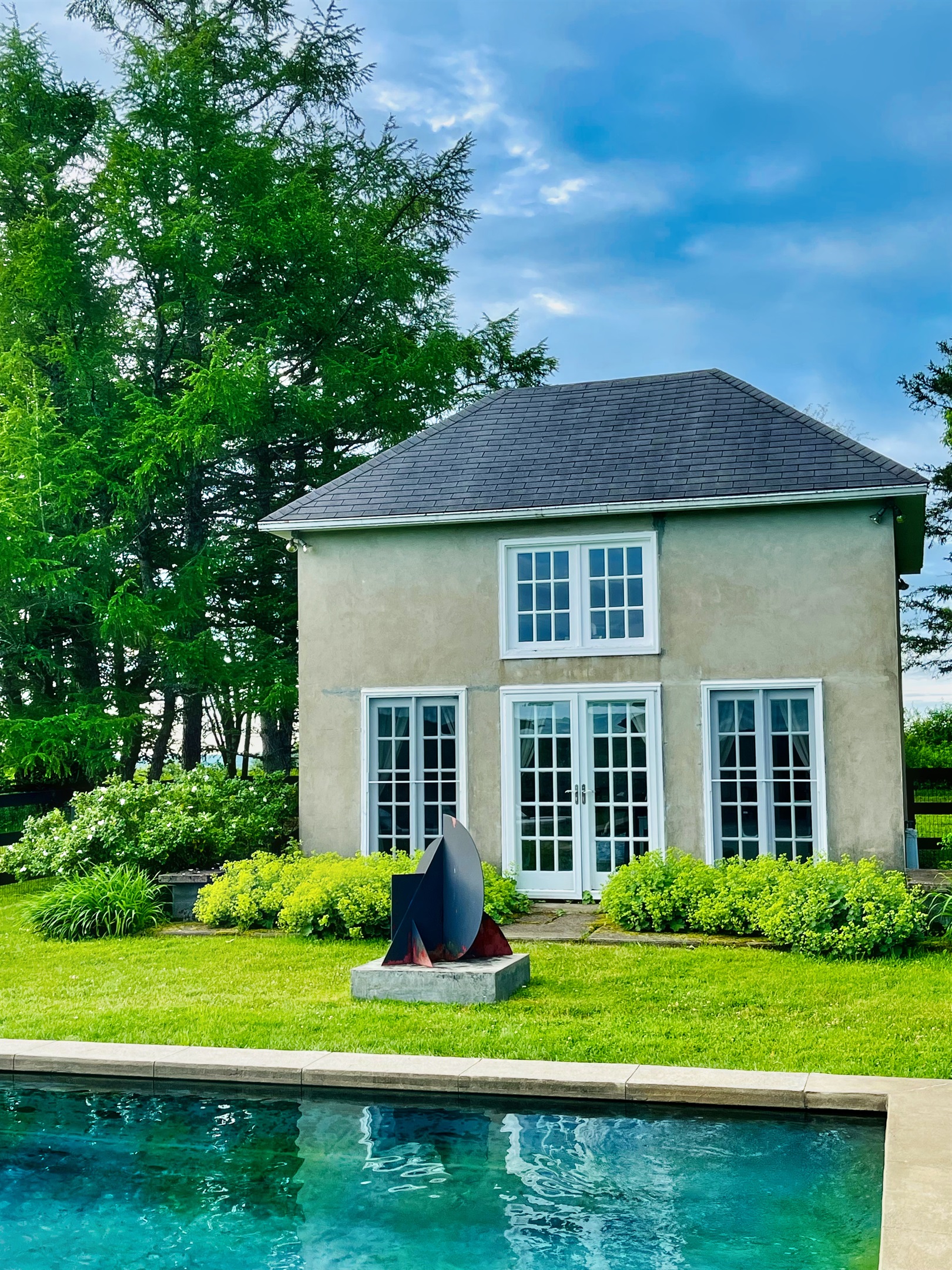 Hawk Field Pool House sculptures adorn the ground around the pool area.