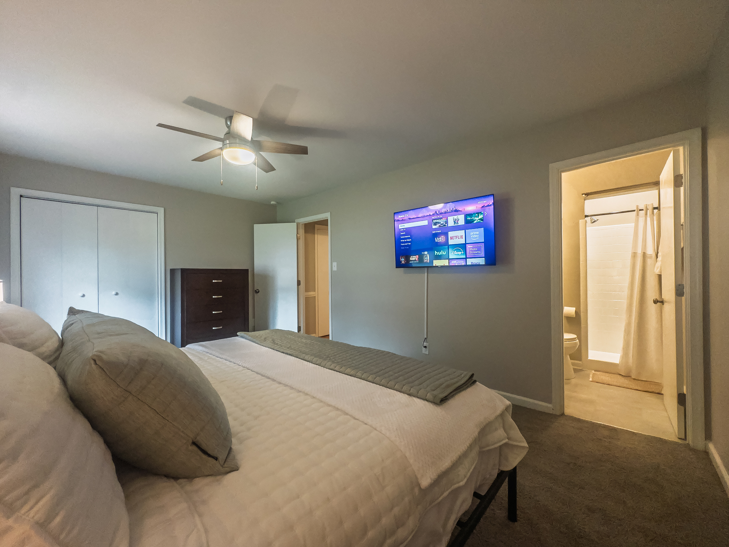 Primary Bedroom, King bed, 55" Smart TV, ceiling fan, two led light nightstands with multiple charging ports, two multi light function lamps, blackout curtains, dresser and closet, private full bathroom.