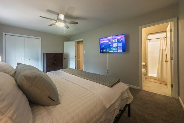 Primary Bedroom, King bed, 55" Smart TV, ceiling fan, two led light nightstands with multiple charging ports, two multi light function lamps, blackout curtains, dresser and closet, private full bathroom.