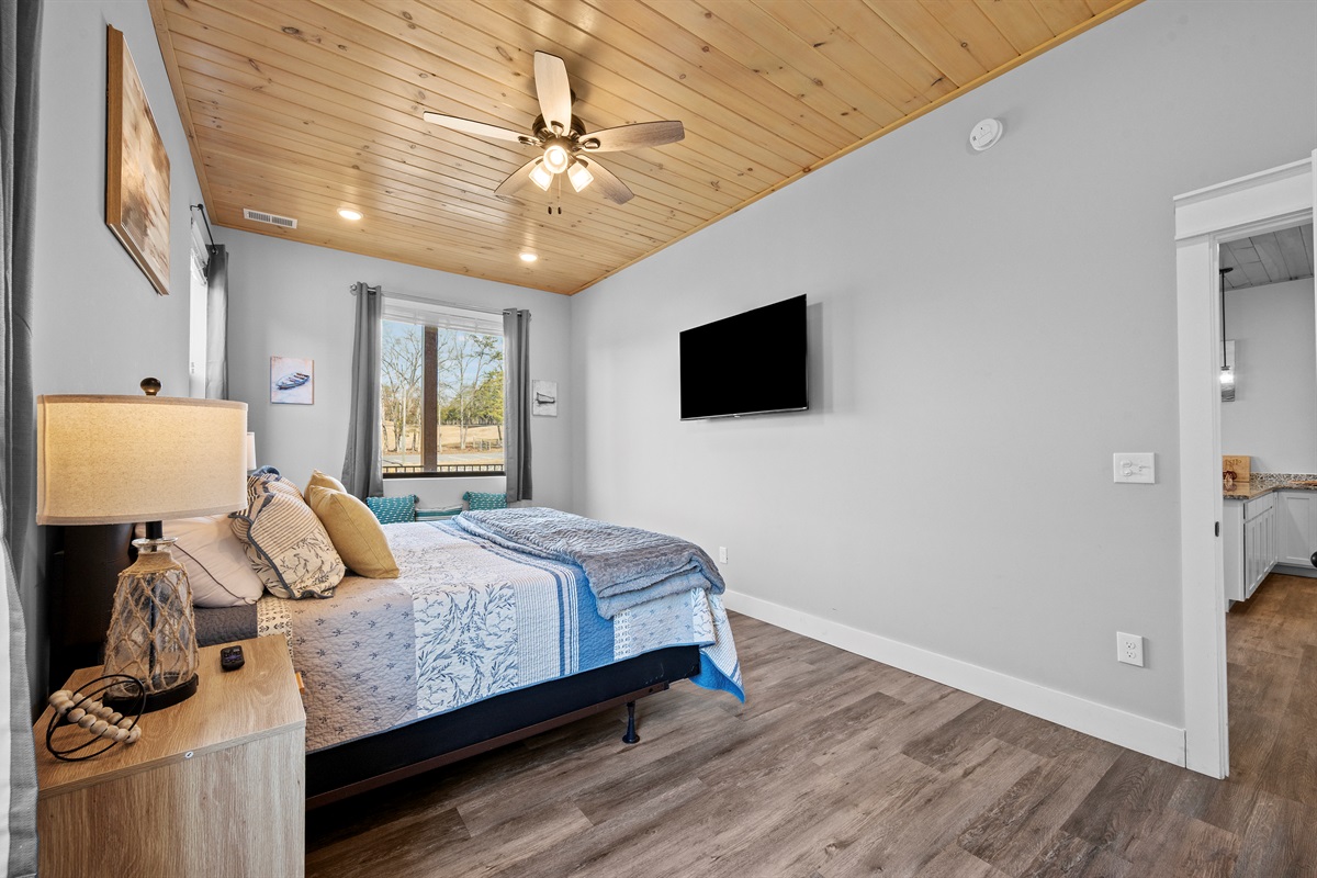 Spacious bedroom with clean design, natural light, and easy access to a full bathroom. Comfortable and inviting for guests of all ages.