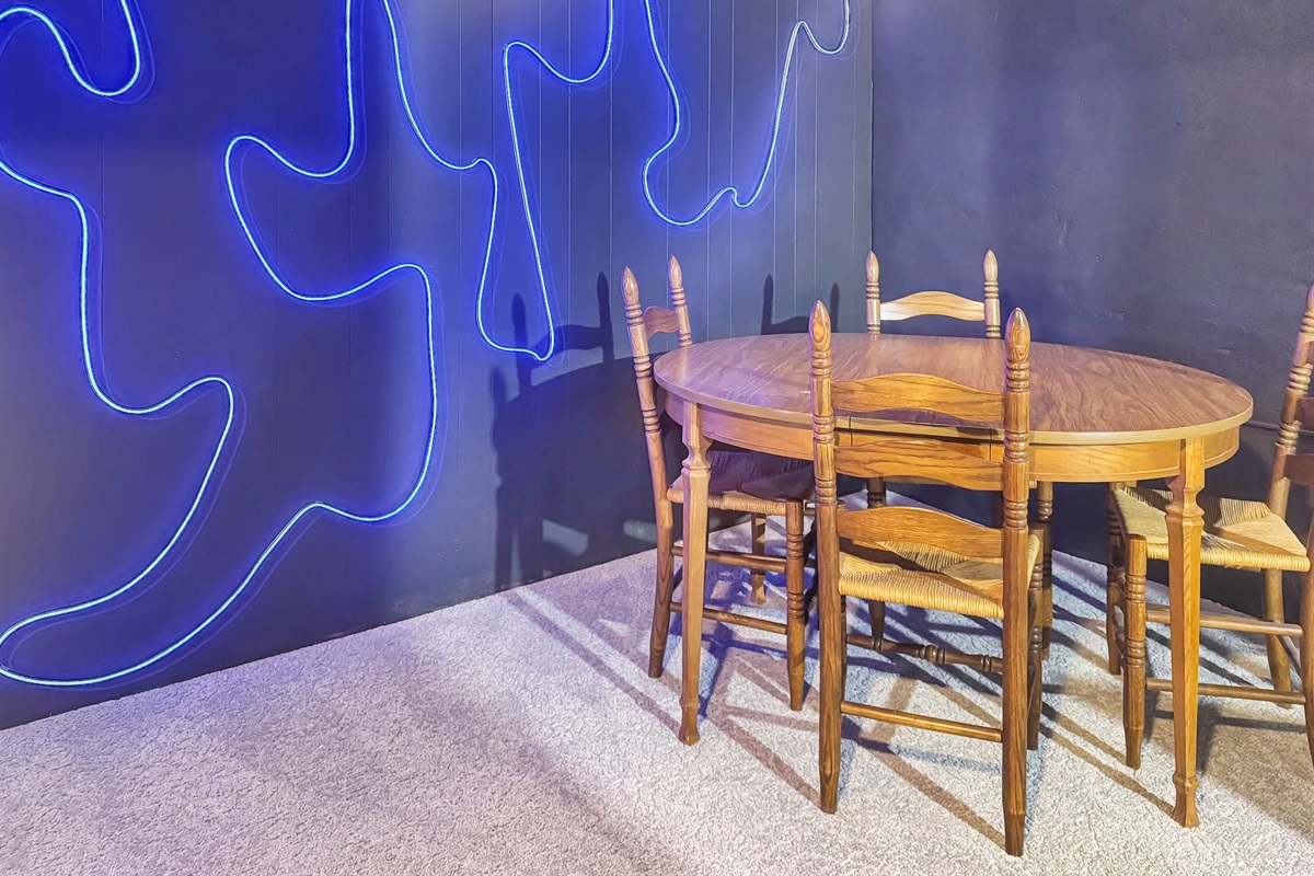 Unwind downstairs: big screen TV, gaming, and neon lighting.