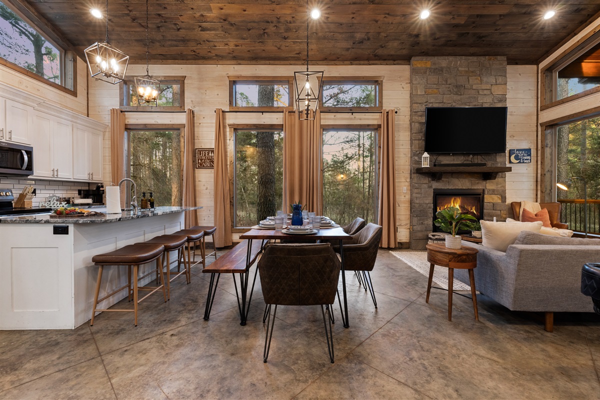 Golden hour pours through the towering windows. Dine together, cozy up by the fire, and let the forest frame every moment in this modern cabin retreat.