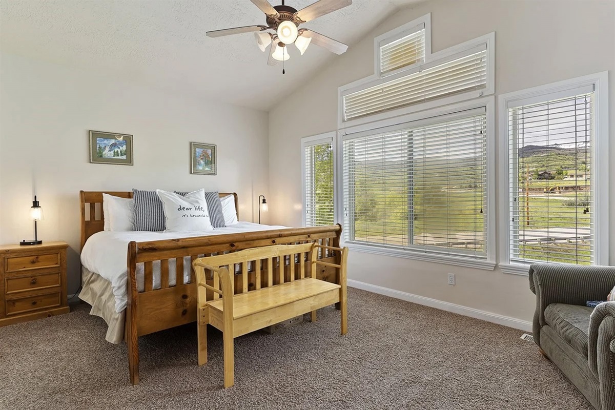 Unwind in this serene primary suite featuring large windows, soft natural light, peaceful mountain views and quiet elegance—your private retreat after a day of mountain or lake adventures.