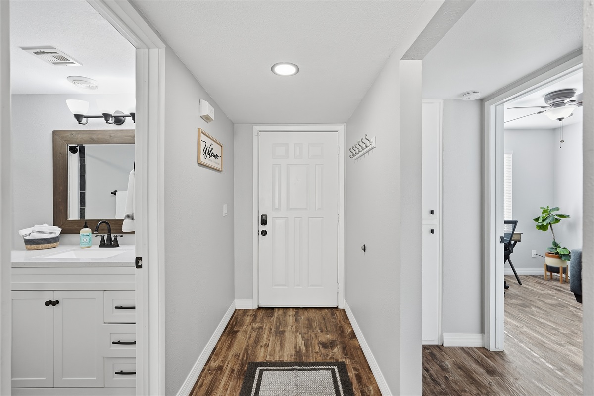 Modern entryway with clean lines, warm floors, and easy access to living spaces.