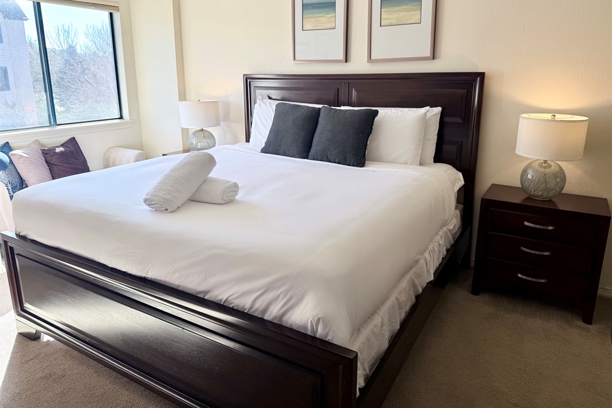 Primary Bedroom with King Bed, comfortable linens, attached bathroom and walk in closet.