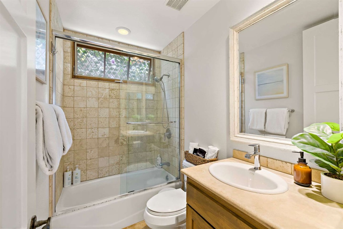 Our bright, clean hallway bathroom is also a full bathroom with a tub/shower and is fully equipped with soap, shampoo, and conditioner.