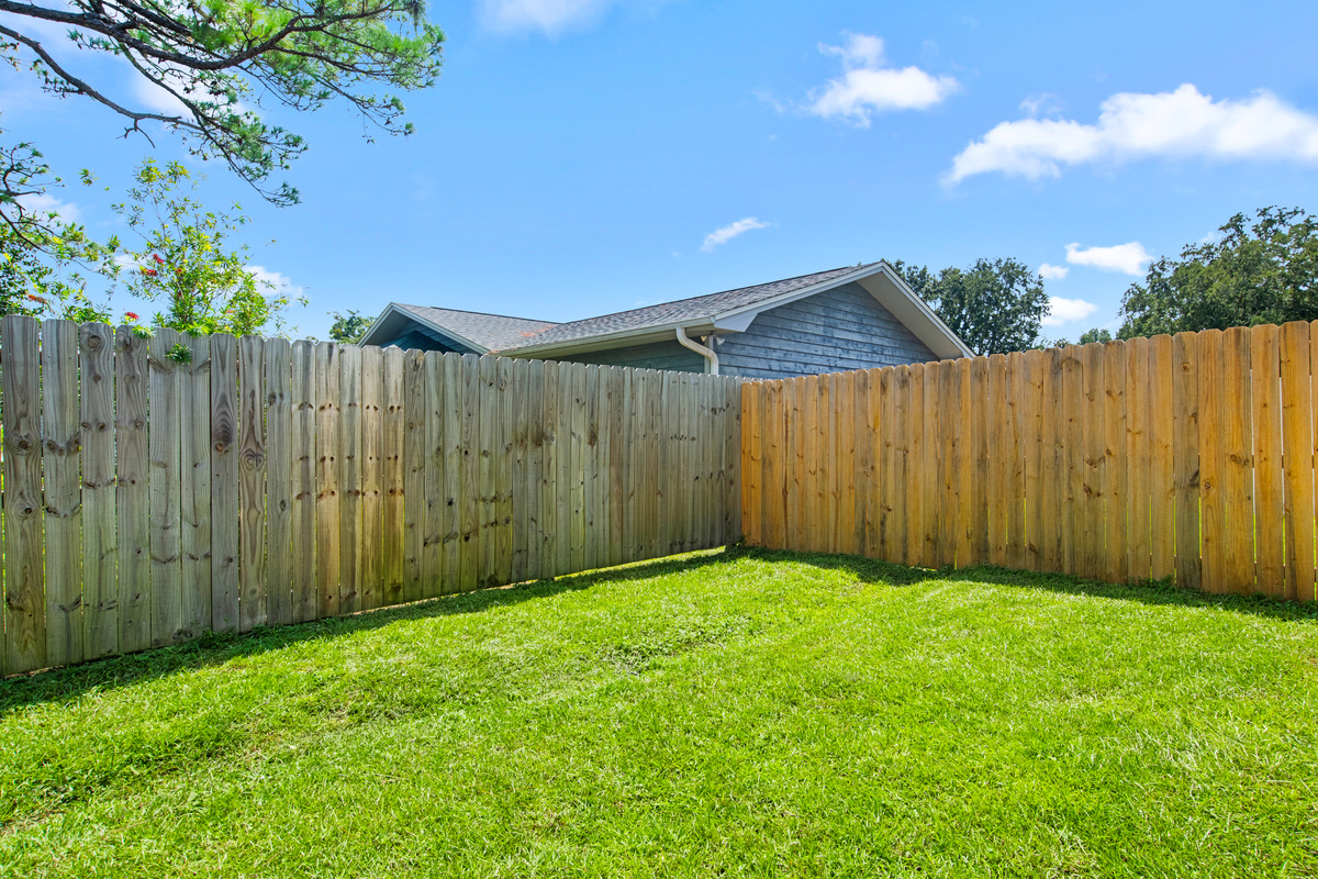 The backyard is fenced on 2 sides.