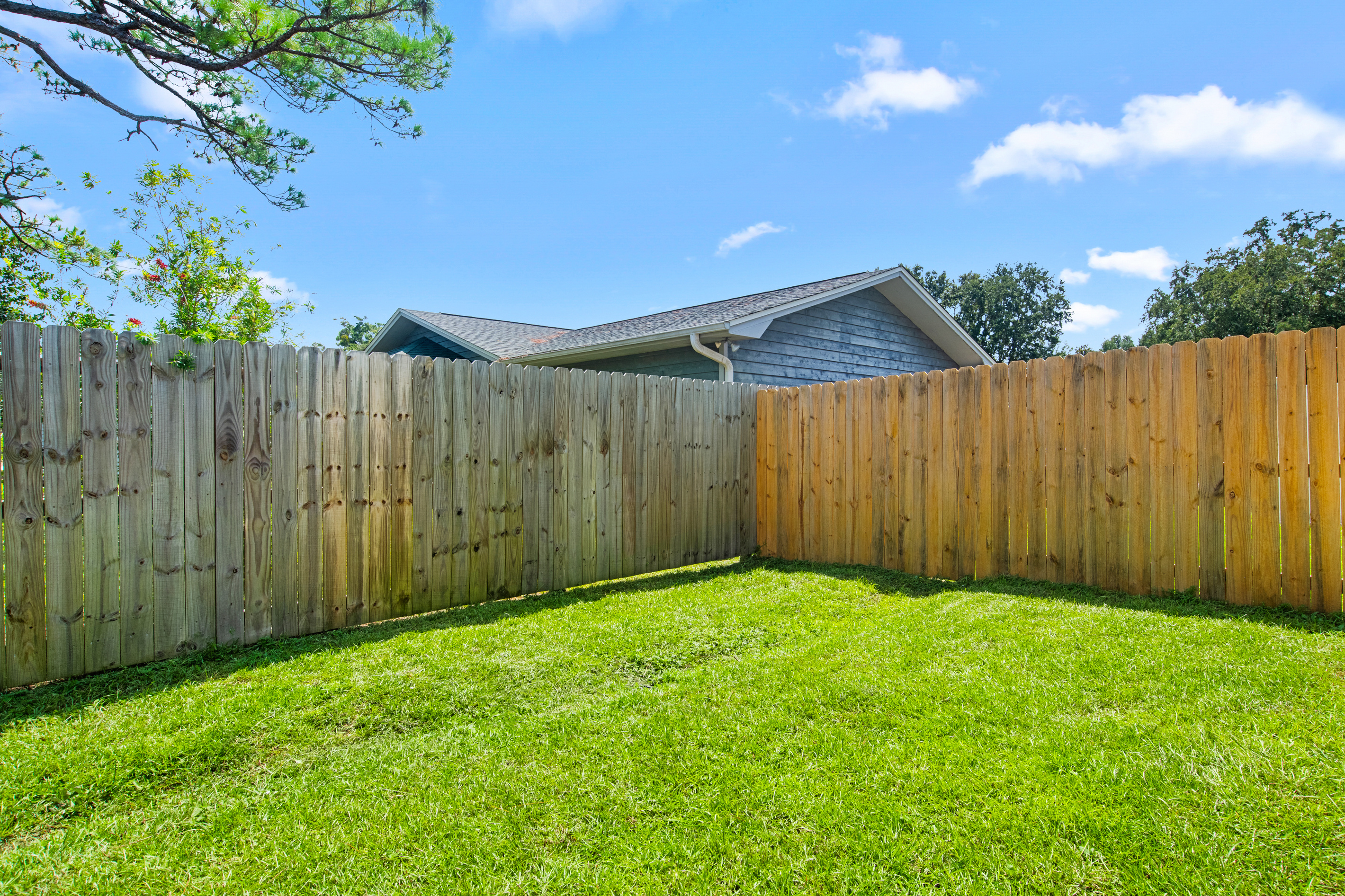 The backyard is fenced on 2 sides.
