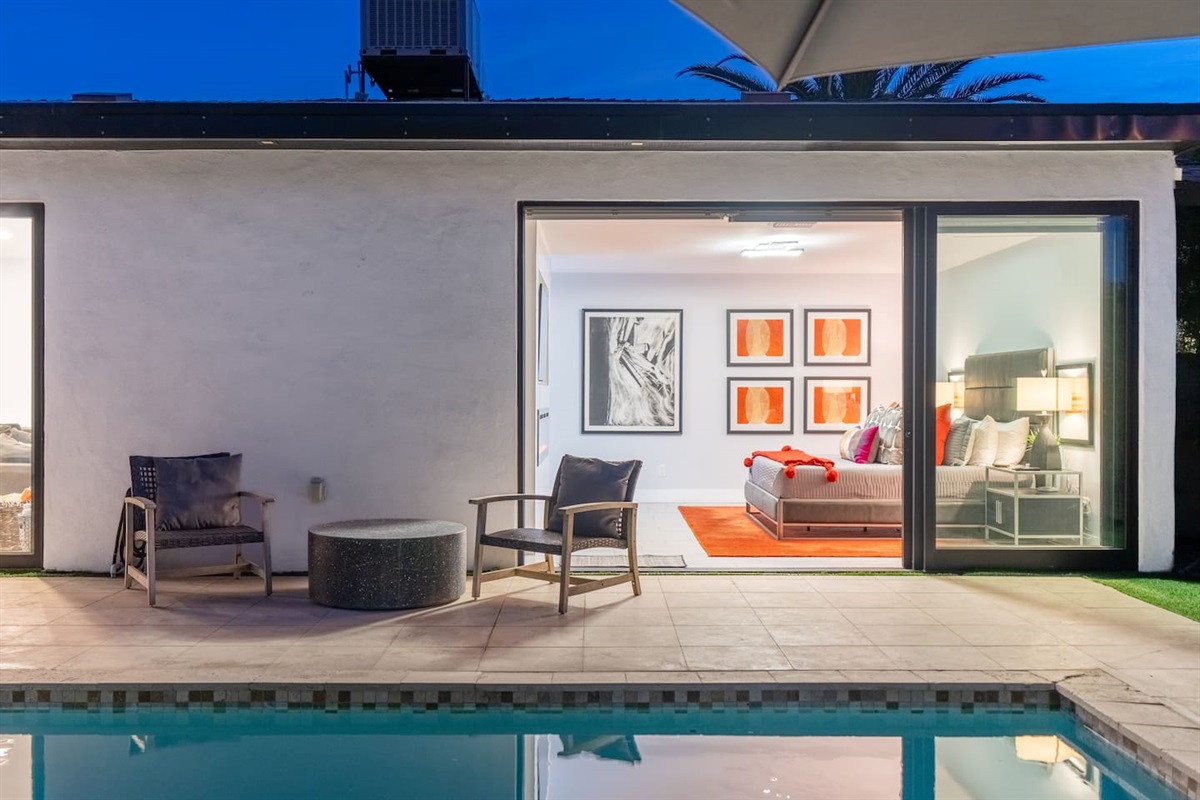 Relax just steps from the pool in this cozy seating nook outside the vibrant bedroom suite.