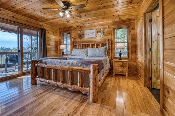 Main-level master bedroom includes a king bed, a private full bathroom, and mountain views! The screened-in patio is right off the master bedroom. 