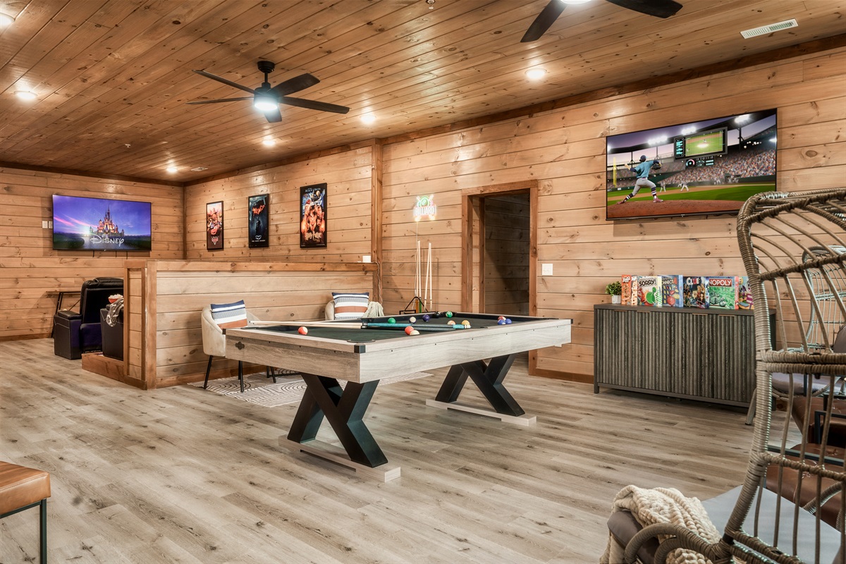 Game Room with pool table, arcades, other games and TV, Theater in background