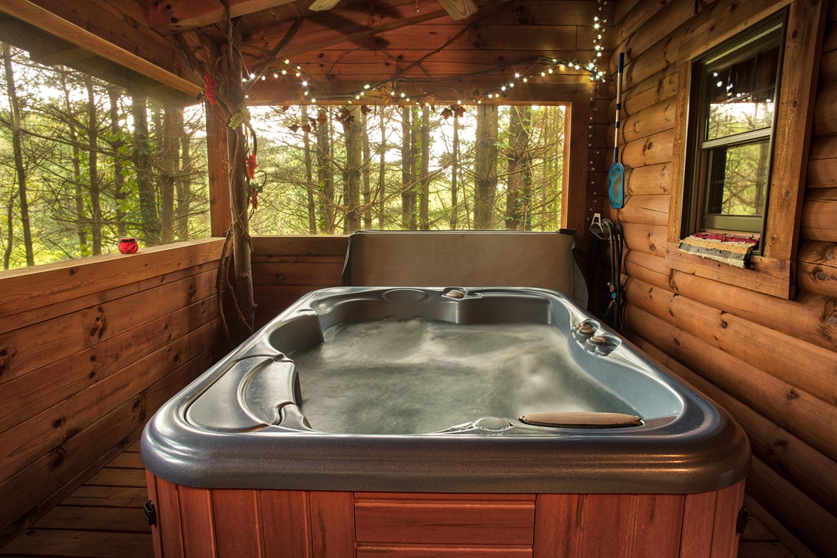Hidden on the screened cedar porch, the hot tub offers a tranquil retreat for soothing baths enveloped by the soft sounds of the forest.