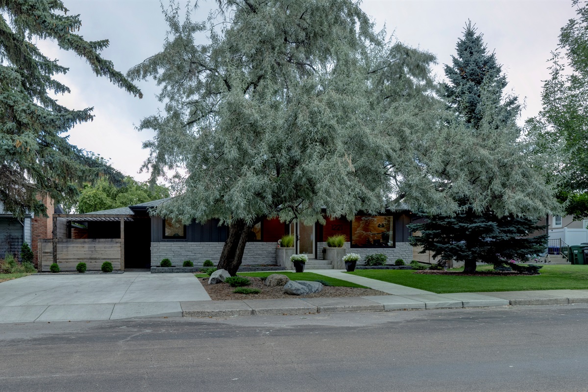 Street-level view of the home within one of Saskatoon’s established residential neighbourhoods.