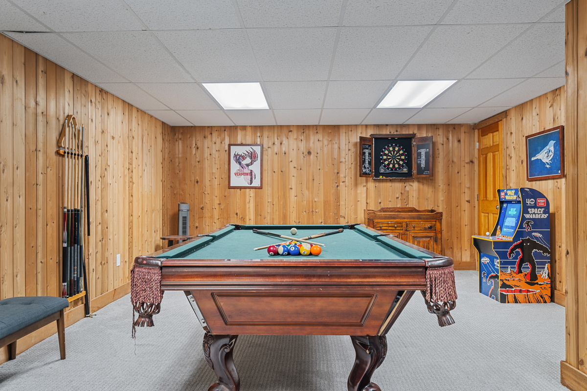 Pool table and classic arcade cabinet in the game room at First Chair Lair