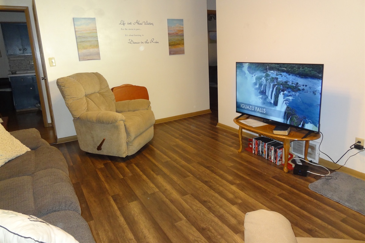 Living room with 2 recliners, reclining couch and Roku smart TV