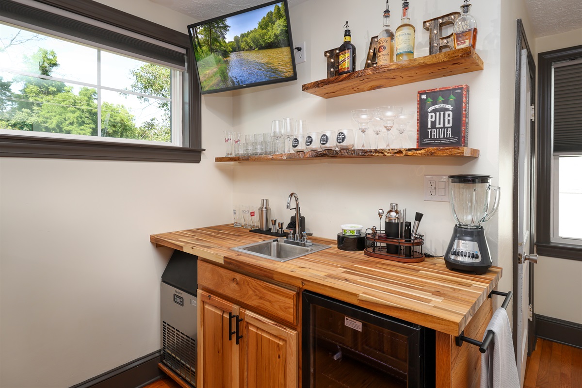 Full Bar with seating, ice machine, sink, refrigerator, bar ware, glasses