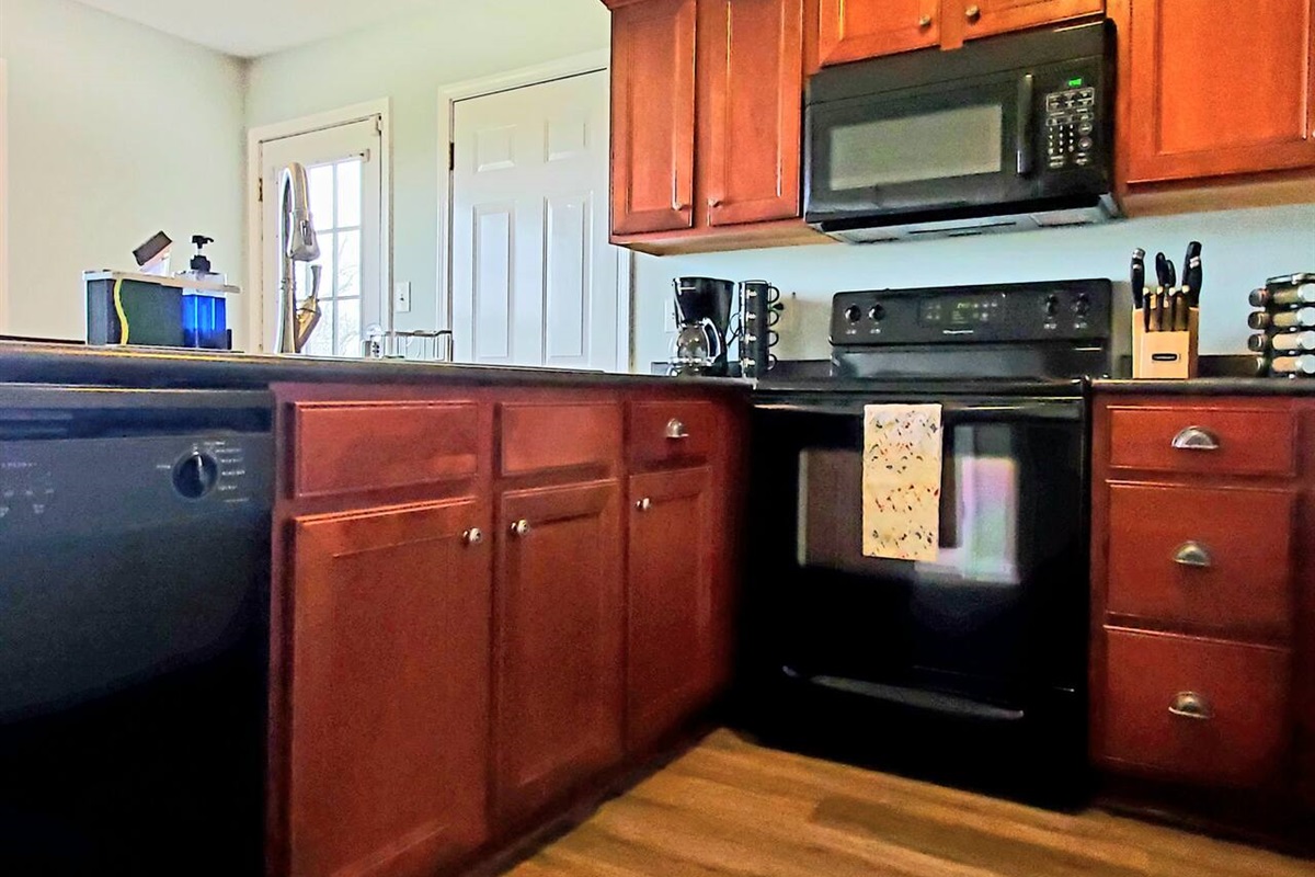 Fully stocked kitchen with spices, cookware, plates, cups, bowls, fridge, stove, microwave etc. Everything you need for a fancy meal or simple food prep. Coffee pot included! Trust us to handle all of your lodging stress.