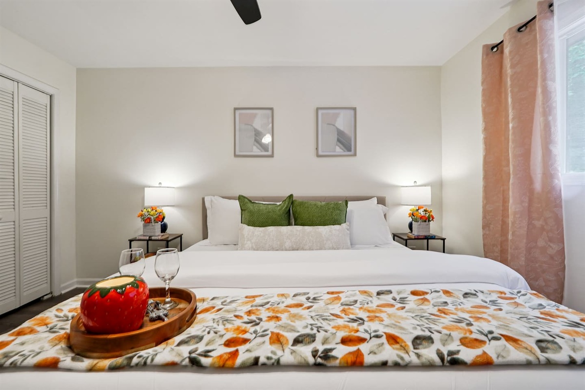 Master bedroom featuring a comfortable king bed and an Amazon Fire-powered Smart TV. The shared bathroom is conveniently right next door. This room includes 2 full-body towels, 2 washcloths, and 2 hand towels for your stay.