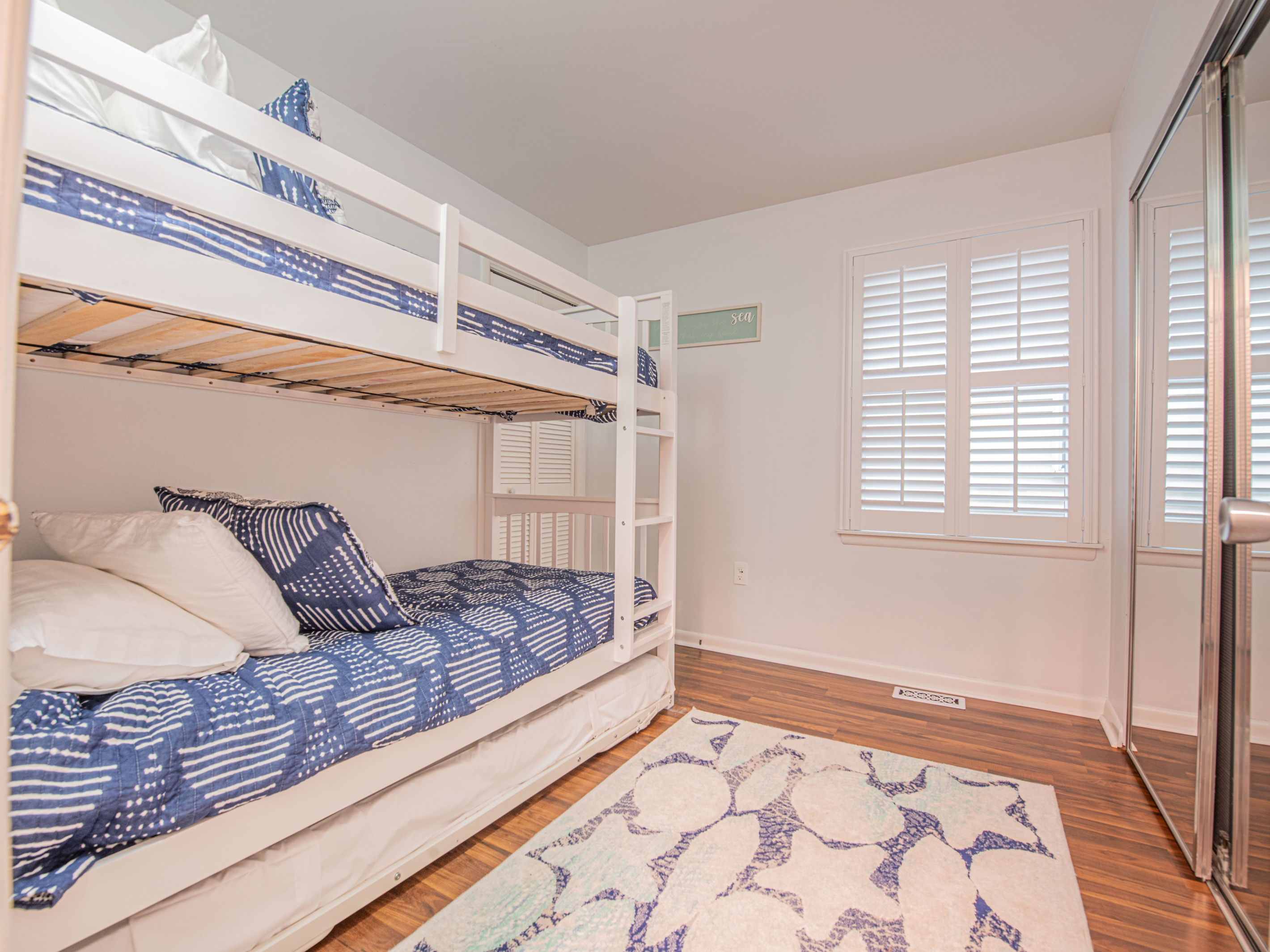 Bunk bedroom-view-towards-mirrored-closet