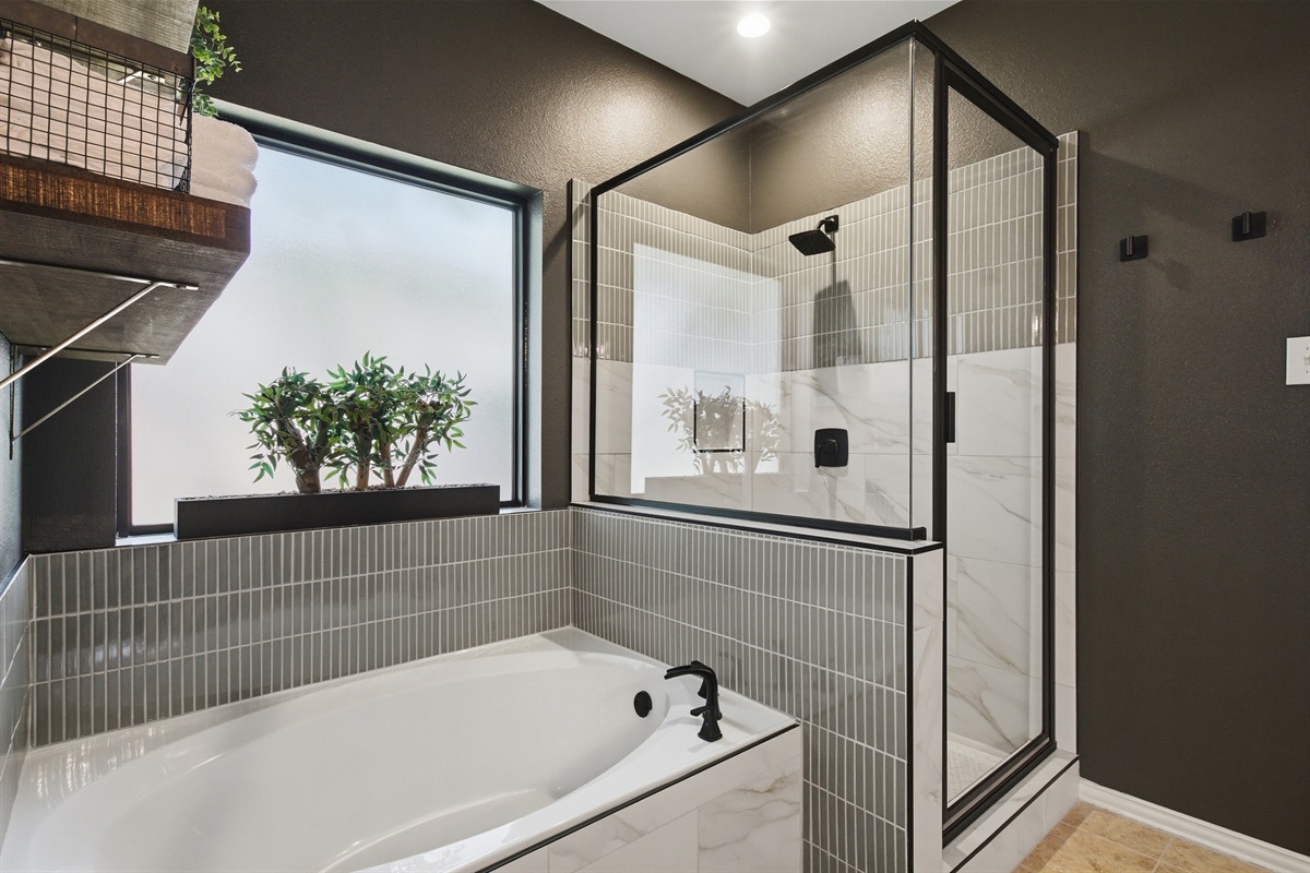 Generous garden Bathtub and separate glass-enclosed walk-in Shower. Relax with a soak after a day at Stonebriar Country Club or Lake Lewisville. Stocked with essentials by Ginger Lily Farms.
