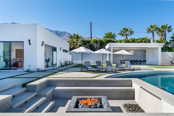 Sunken fire pit with waterfall and seating