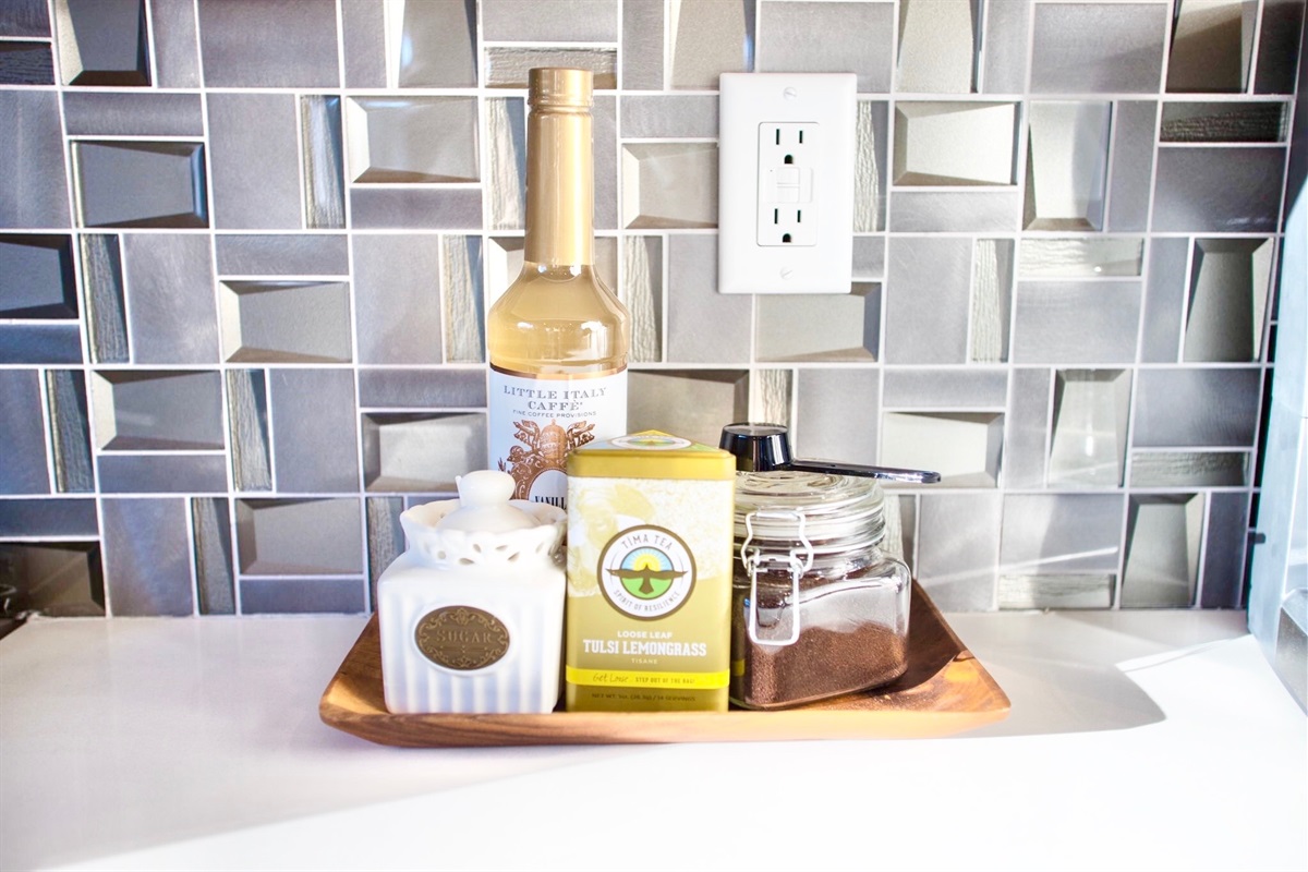 - Start your morning right with this charming corner stocked for sips and slow moments - Enjoy options from herbal tea to rich ground coffee, all within easy reach - Thoughtful touches and a sleek backdrop make every pour feel just a little more special