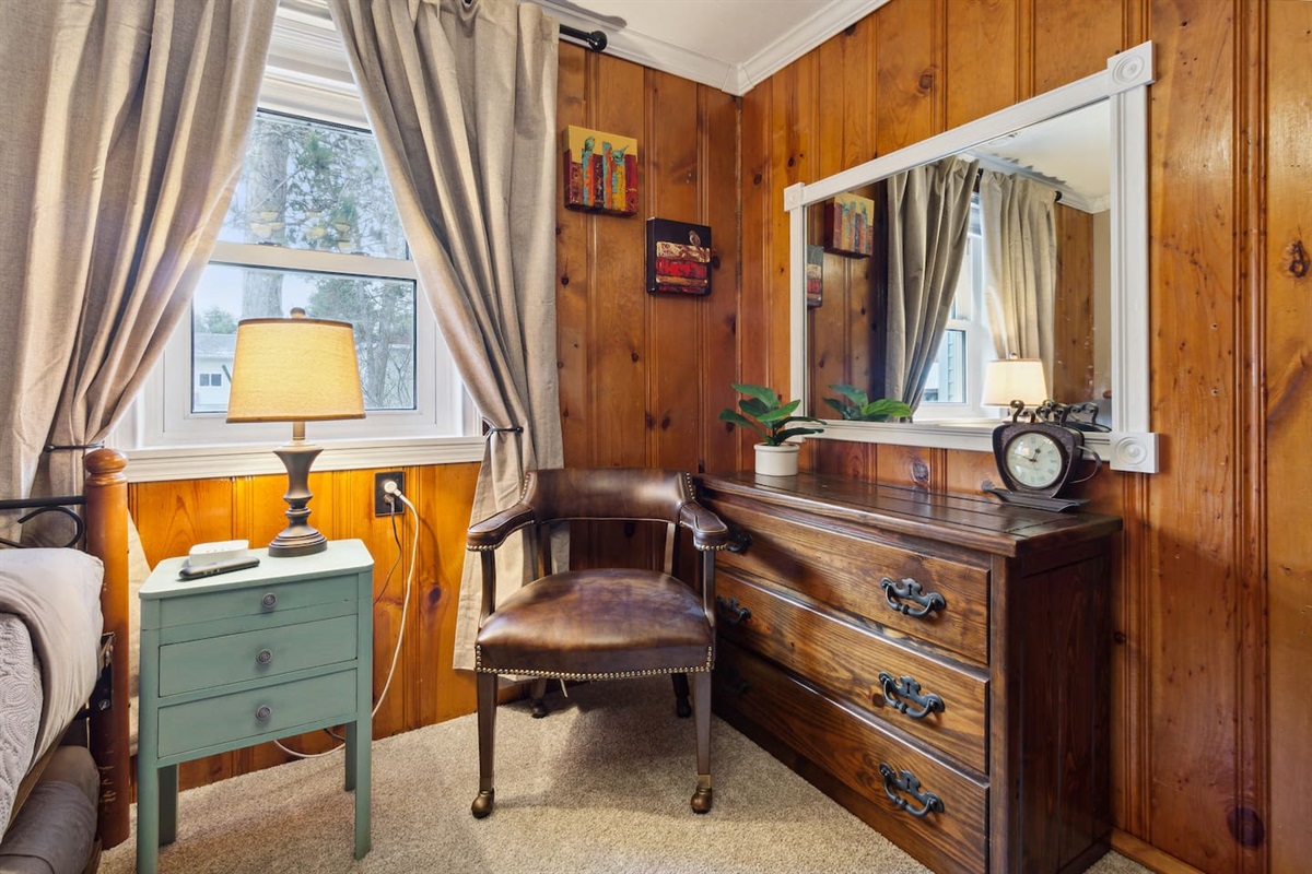 Three-drawer dresser to organize your things, large mirror,  and plenty of top space for your larger items. Chair is located in the living room for more seating.