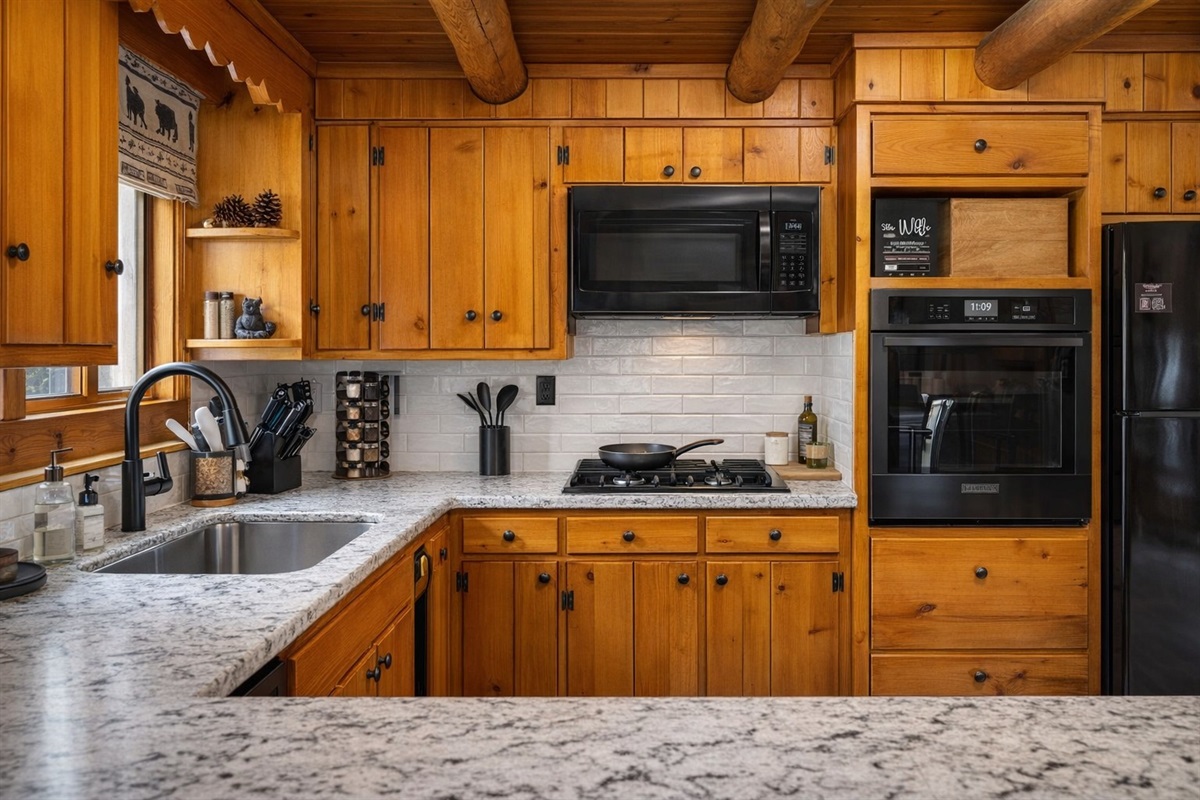 Gather for meals in our spacious kitchen and dining area—plenty of room for the whole crew with seating for 8 and a view of the woods through every window.