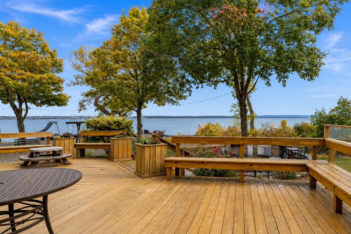 Expansive deck with seating for family gatherings and lakefront dinners.