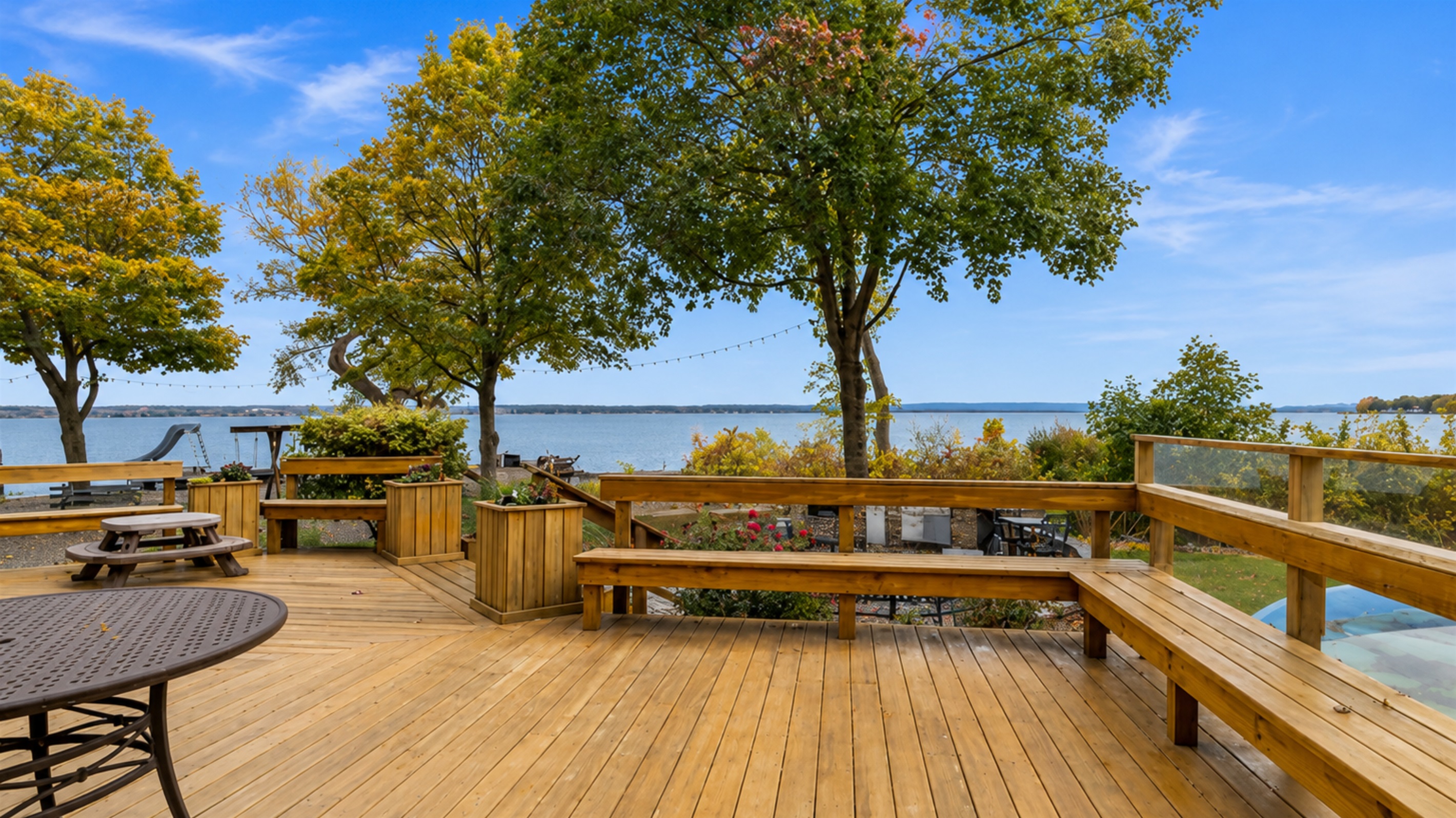 Expansive deck with seating for family gatherings and lakefront dinners.