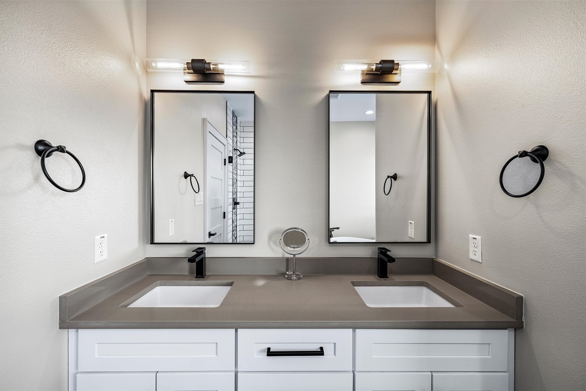 Bathroom: Dual vanities and modern lighting create a perfect space for relaxation and refreshment!