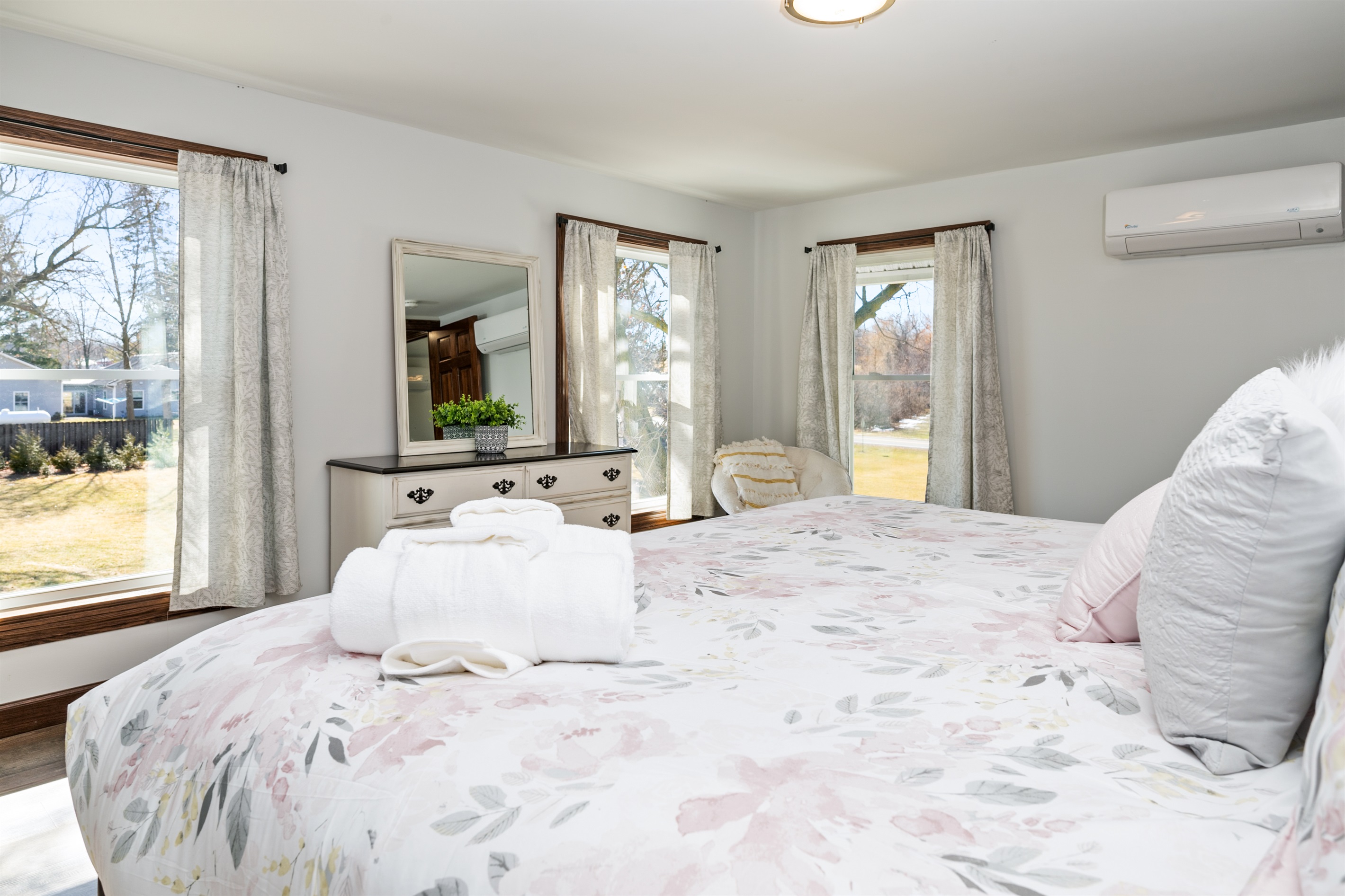 Bright, spacious bedroom with cozy seating and views of the scenic outdoors—perfect for morning coffee or unwinding after wine tasting.