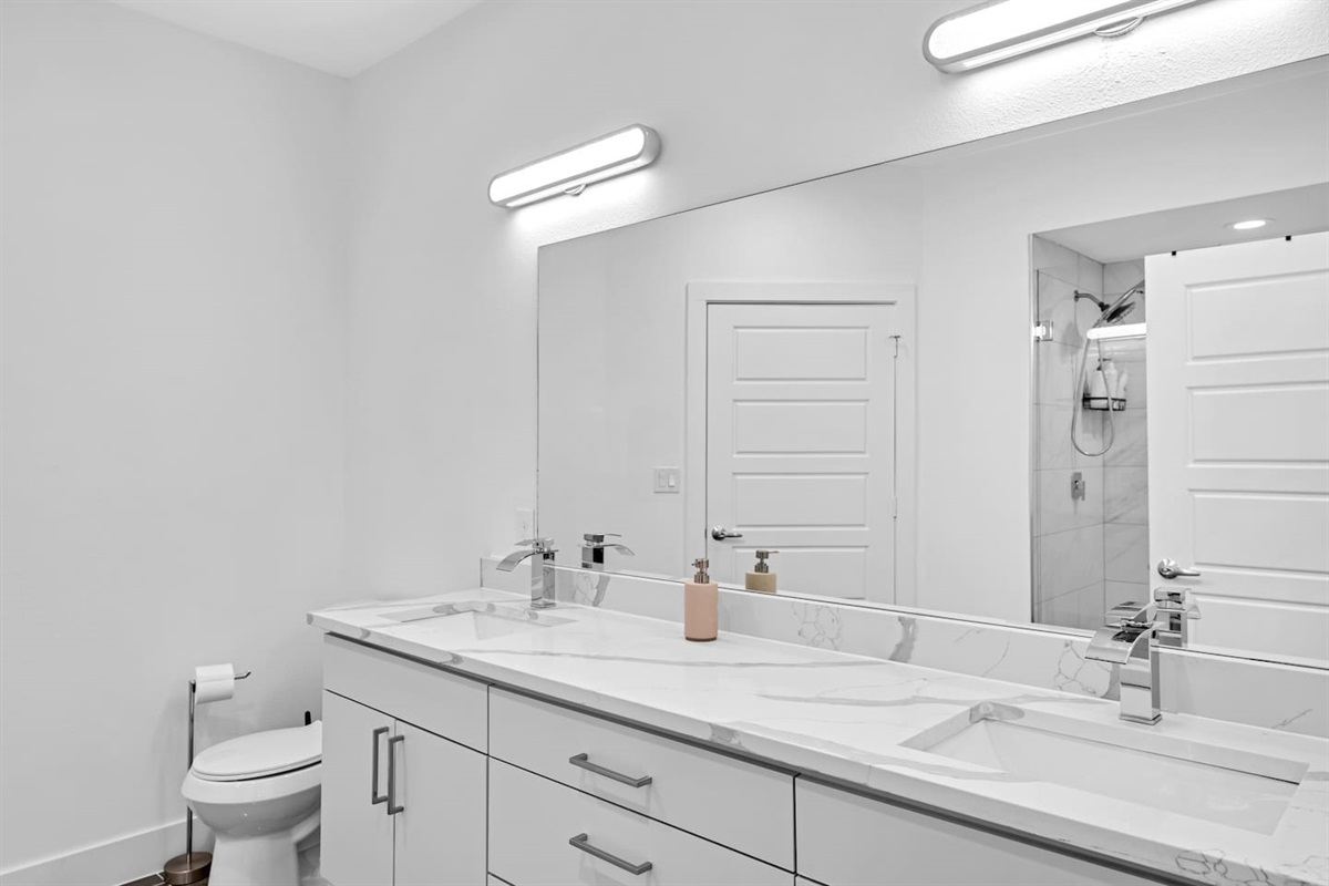 Spa-inspired bathroom with dual vanities and bold modern finishes.