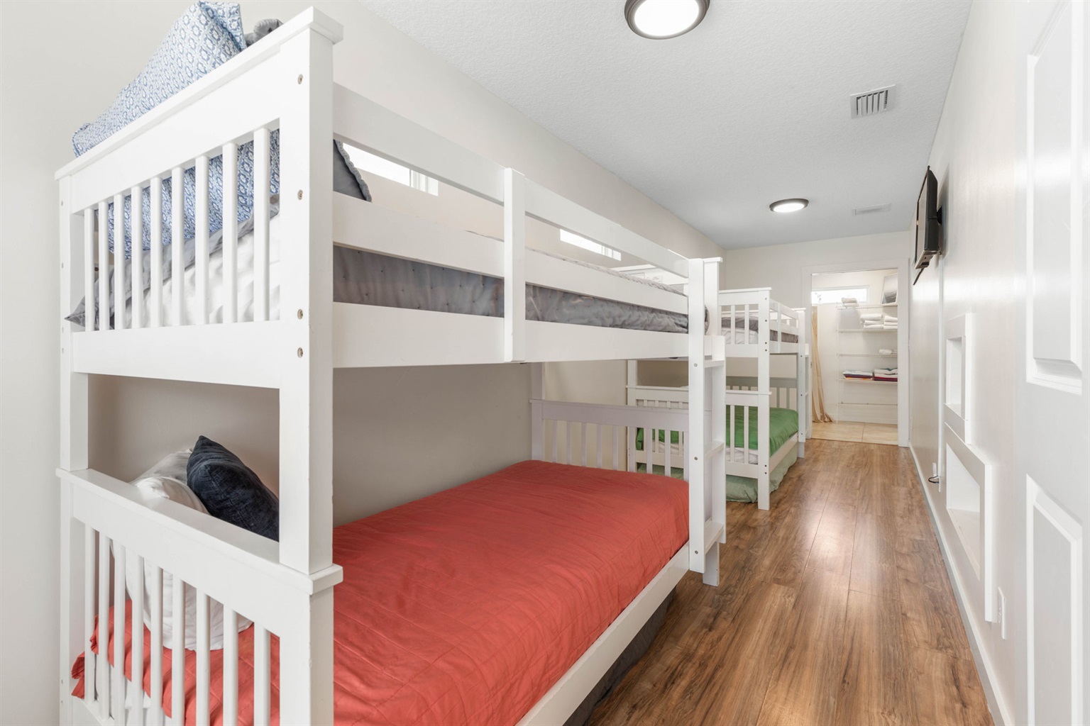 After sun-soaked beach days, this bunk room becomes the kids’ own little world—late-night whispers, movie wind-downs, and sleepy smiles tucked into beds that turn every group getaway into a memory they’ll talk about for years.