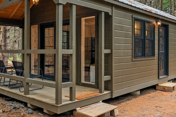 Private cabin with porch in a wooded setting