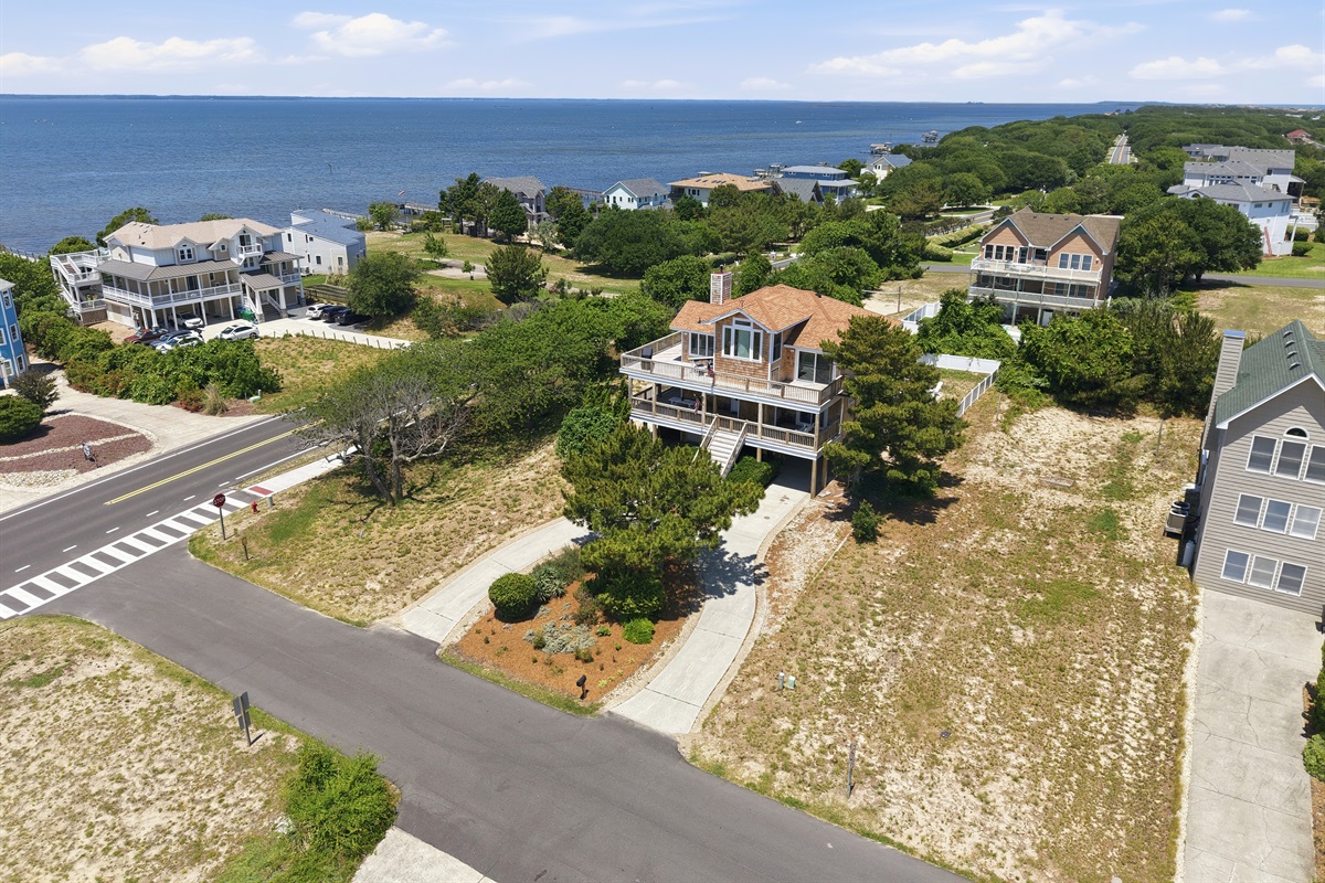 Neighborhood aerial view showing close proximity to the water and beach access