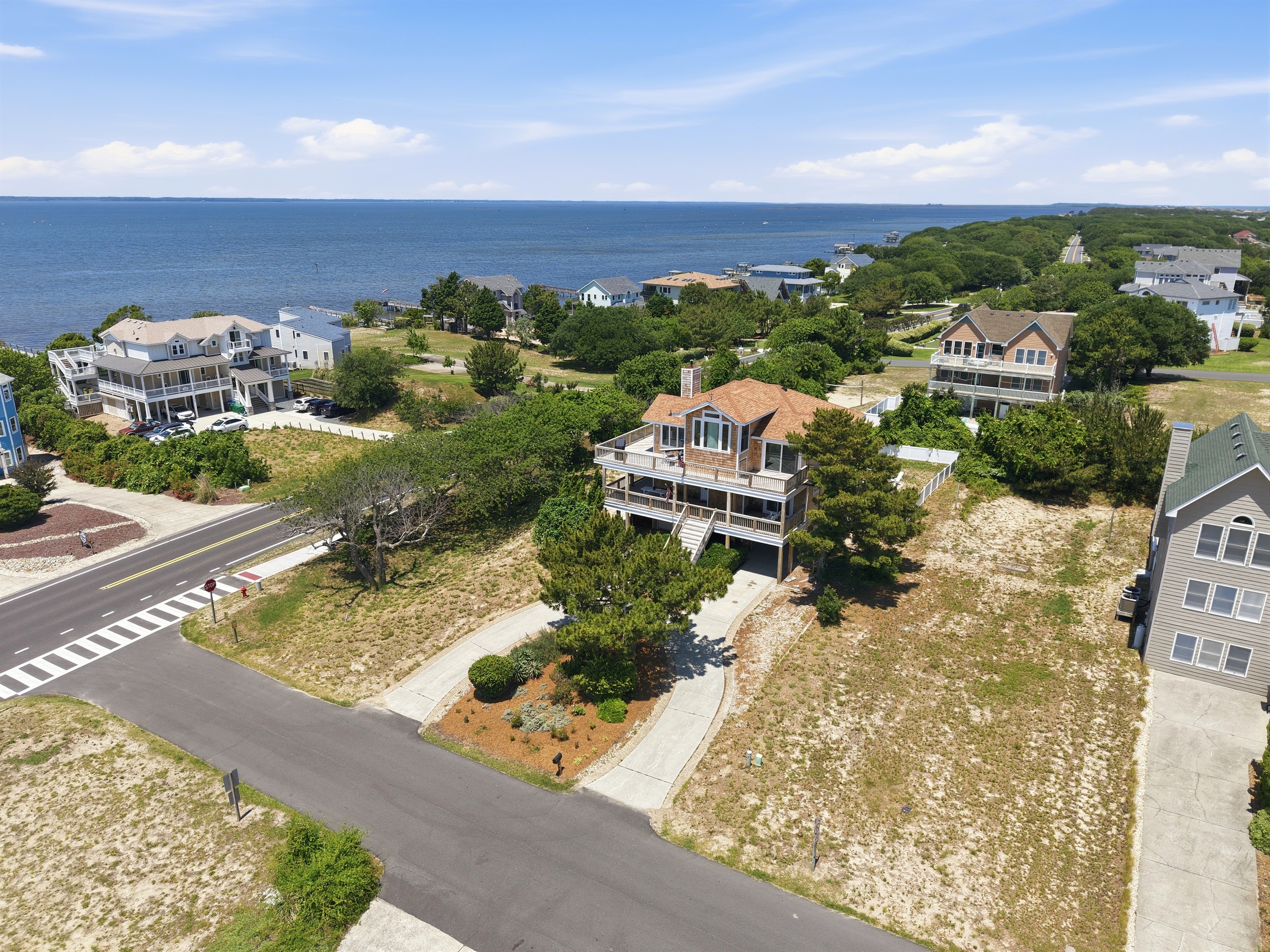Neighborhood aerial view showing close proximity to the water and beach access