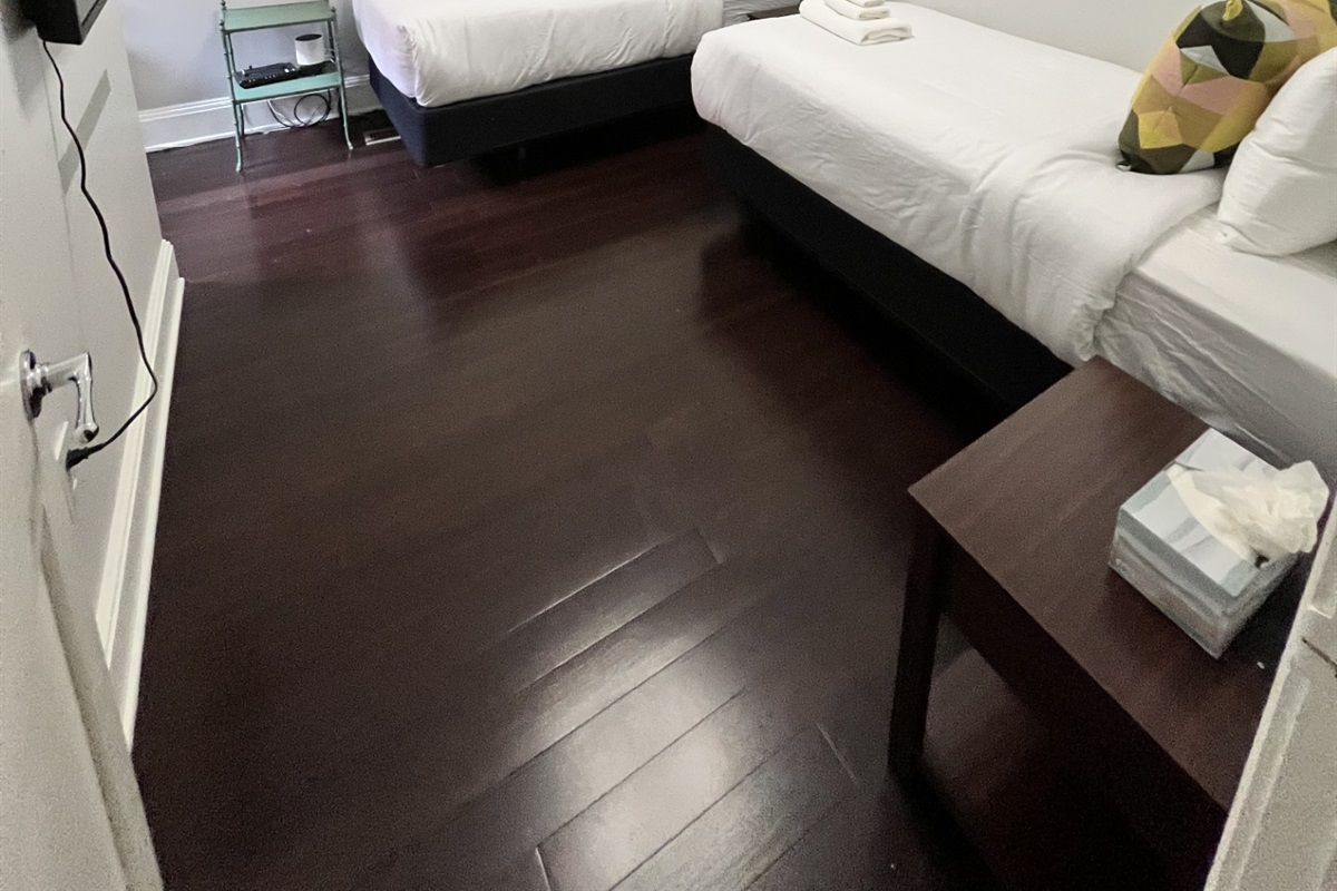 Guest bedroom with two brand-new Beautyrest twin beds and a 32" Roku Smart TV—perfect for friends, kids, or anyone who appreciates flexible sleeping arrangements and easy streaming.