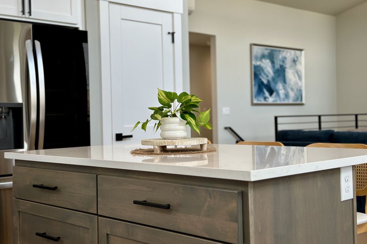 Pull up to the island for early coffee; it opens straight onto the living room, so the cook stays part of the conversation.
