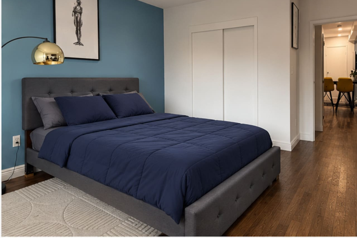 Primary bedroom with sweeping NYC city views — Little Italy Manhattan 2-bedroom apartment
