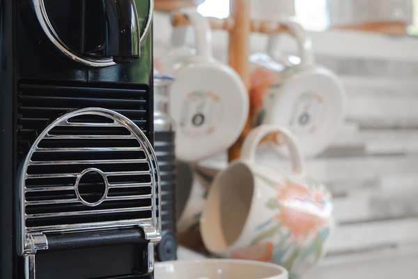 The kitchen includes an espresso machine and mug setup, making mornings at Fernhill Mountain Escape simple before heading out.