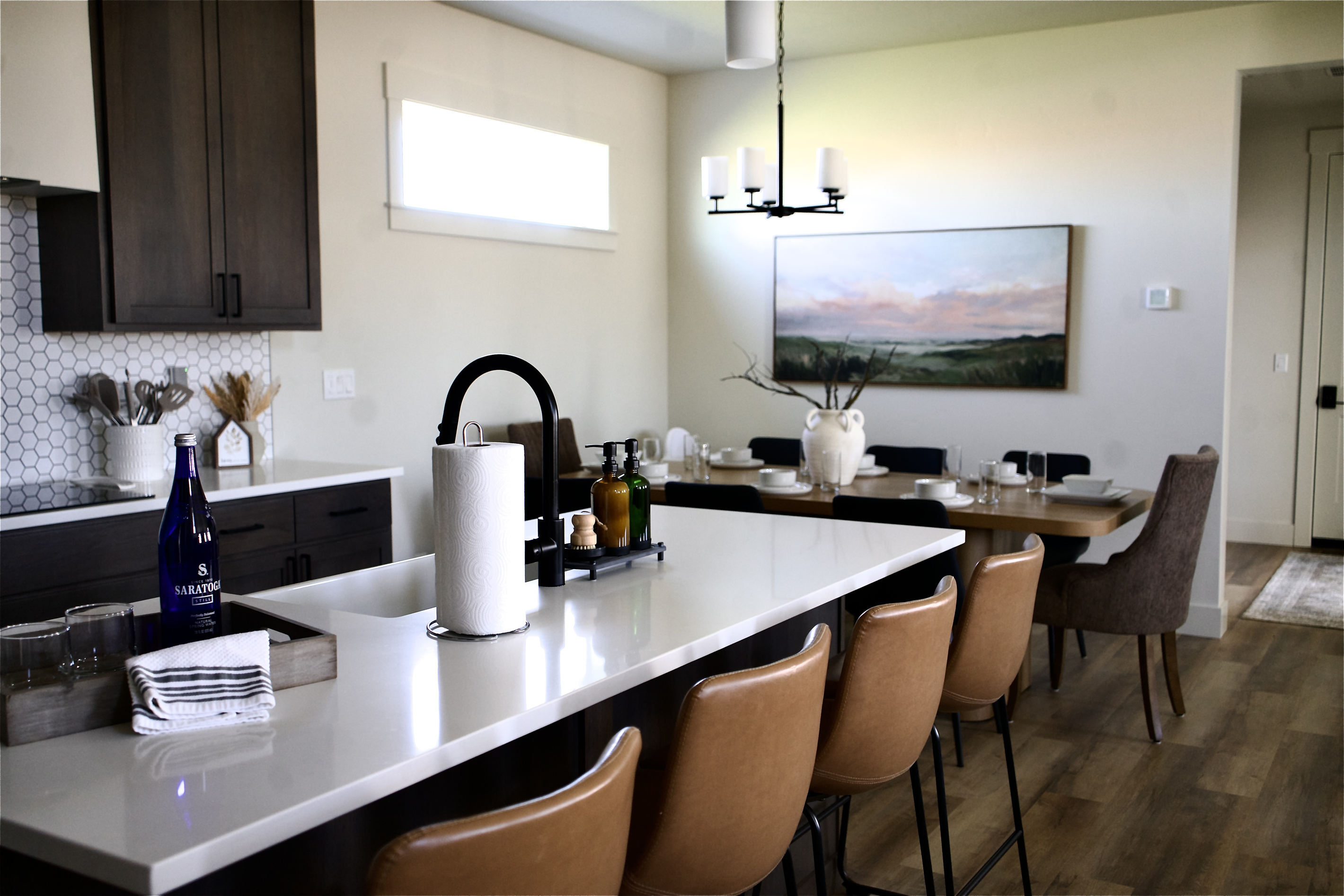 Large, elegant kitchen with seating for up to 12 guests. The open-concept layout flows seamlessly into the living room, creating a bright and spacious area ideal for gathering and entertaining.